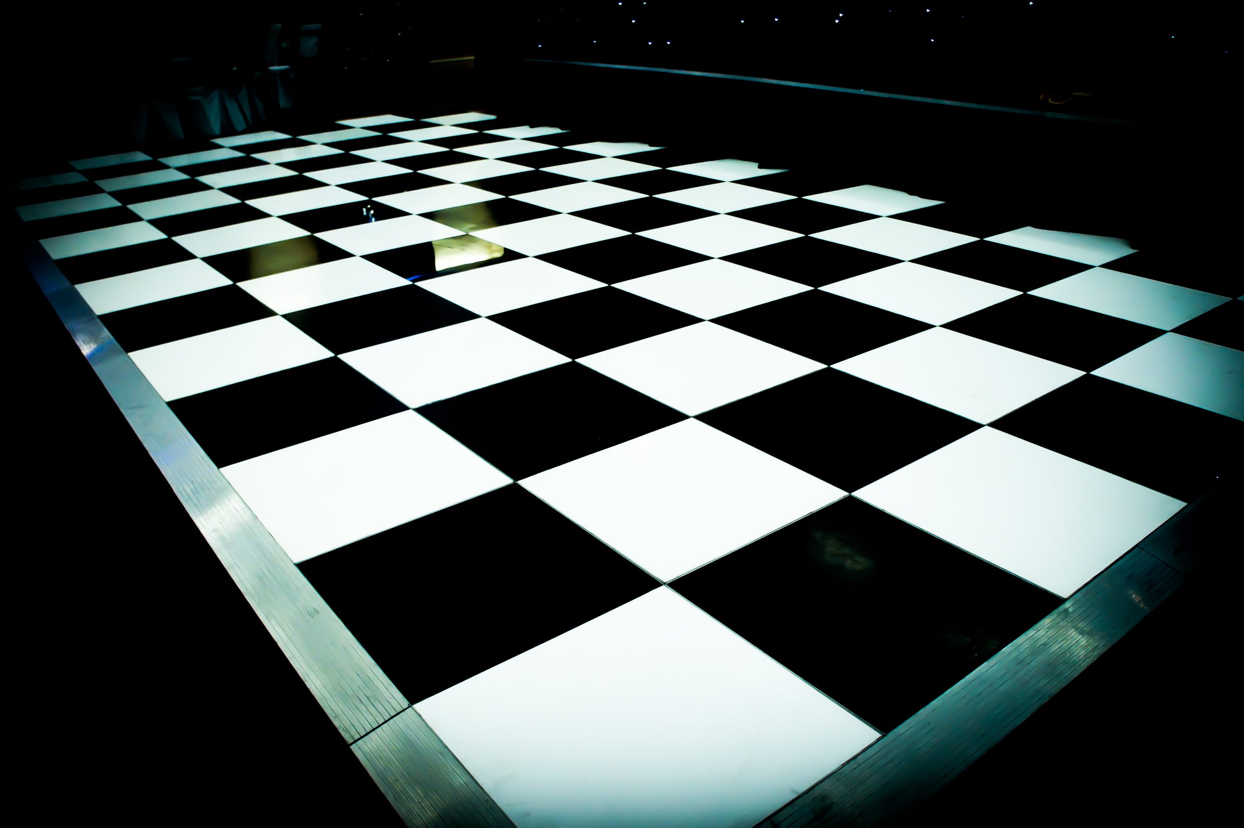 Black and white chequered dance floor with silver trim edging