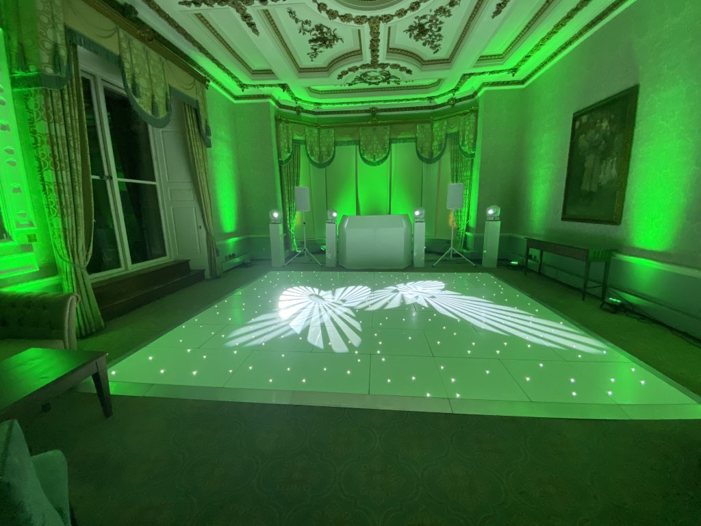 LED white dance floor with green moodlighting and white disco setup
