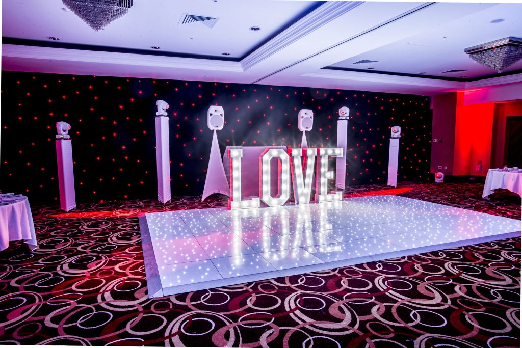White starlit dance floor with LOVE letters and white DJ setup