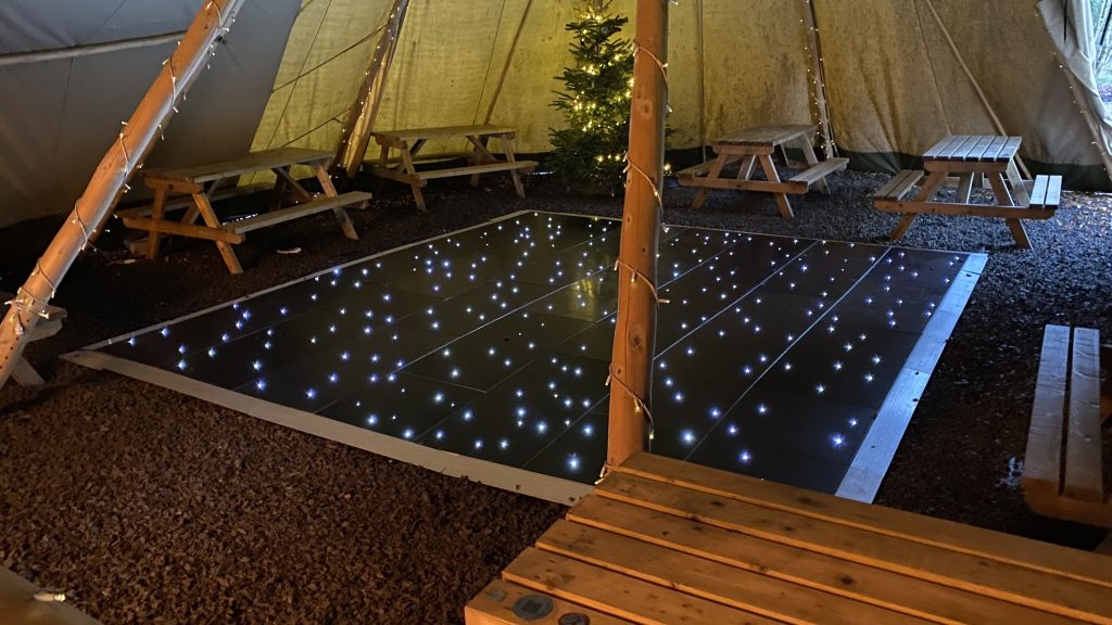 Black led twinkle dance floor at a tipi wedding