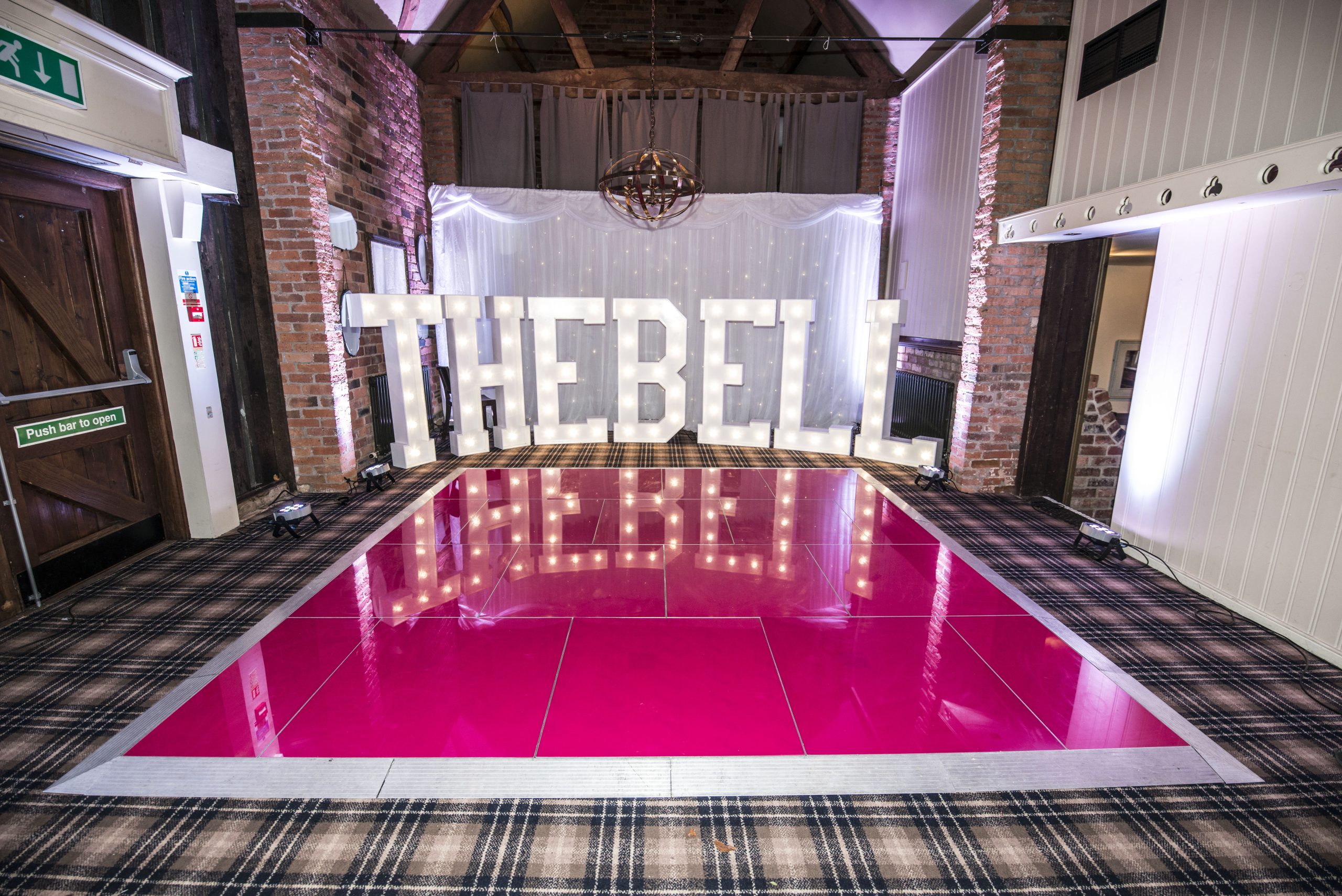 Pink dance floor hire with light up letters and backdrop