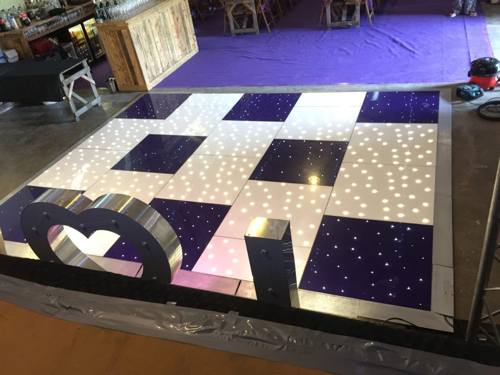 Purple and white twinkle dance floor at Stanway Barn