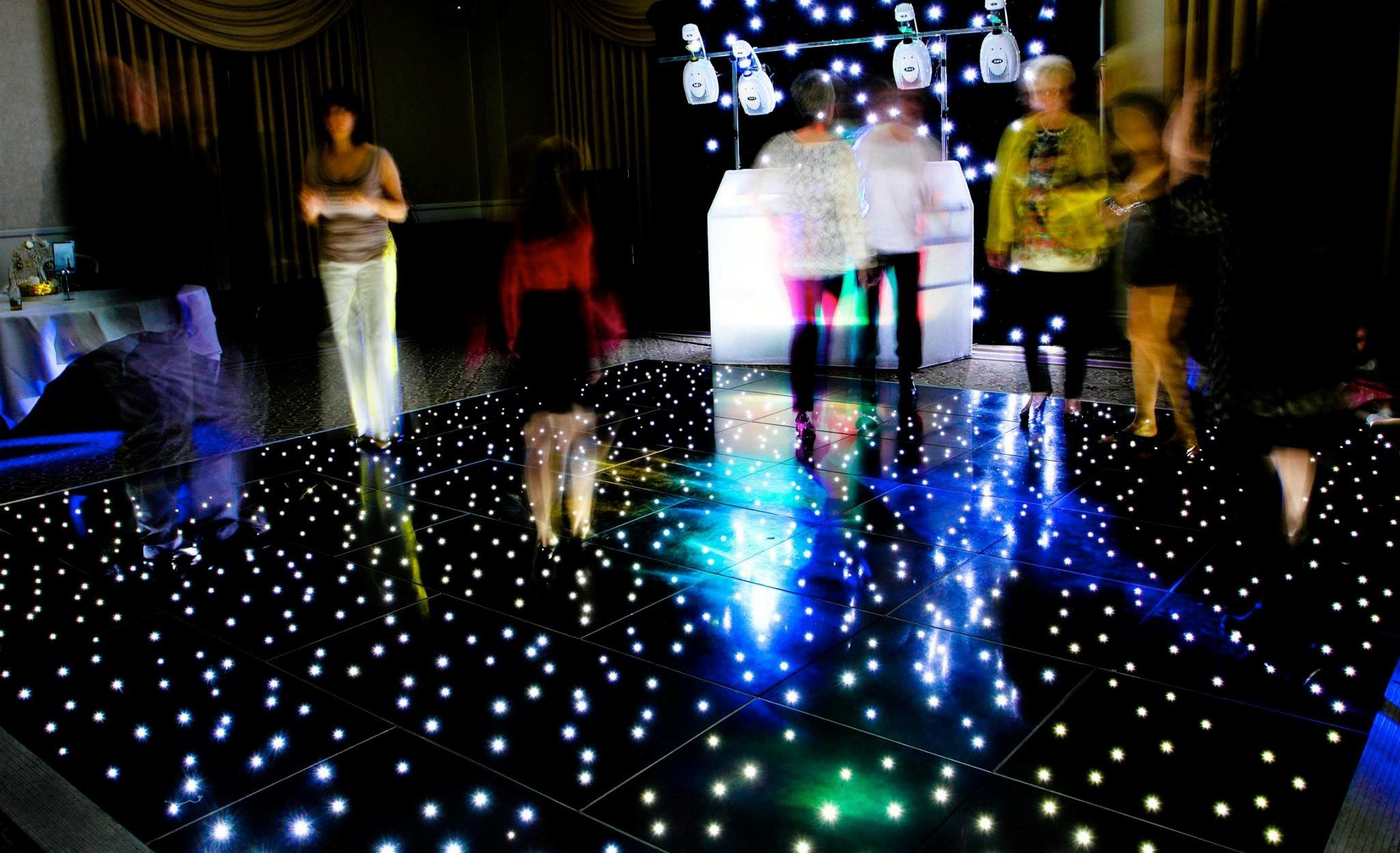 Party time with a black dance floor led with people dancing
