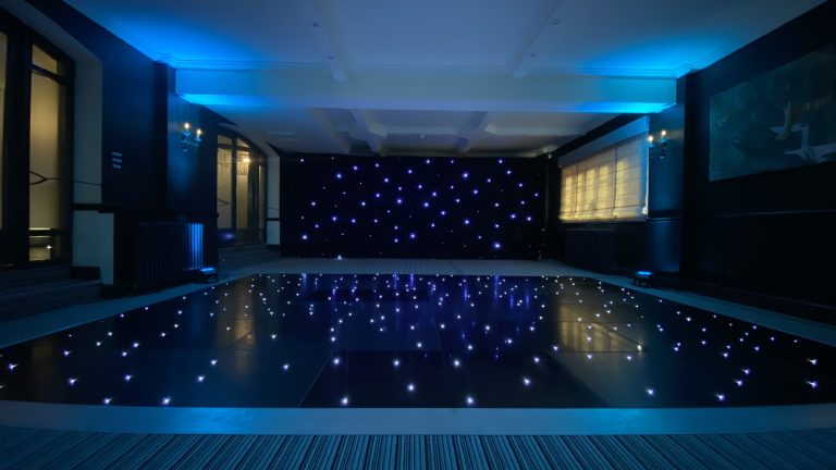 Black led dance floor with light blue room lighting
