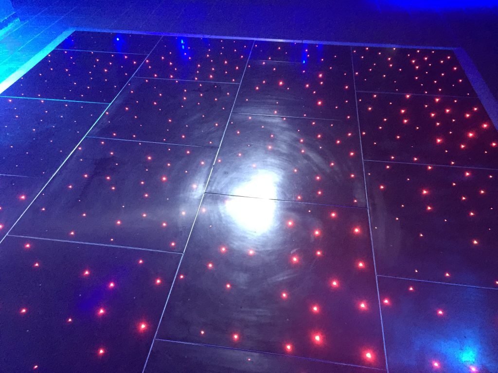 Black starlit dance floor with red leds