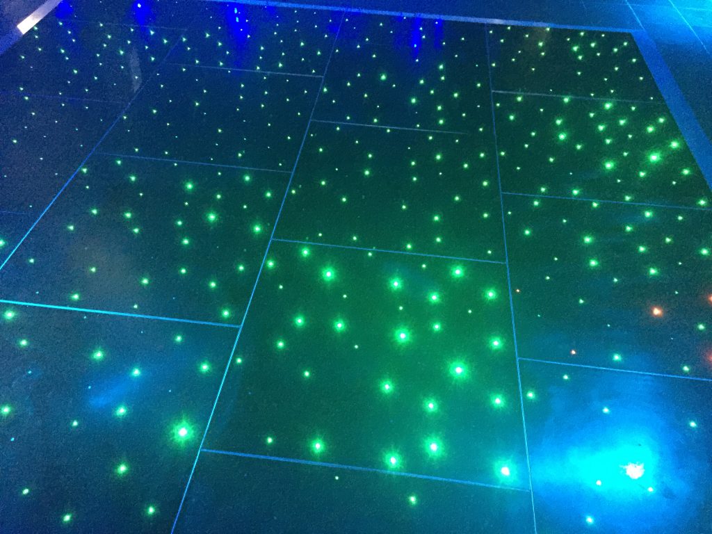 black starlit dance floor with green LEDs