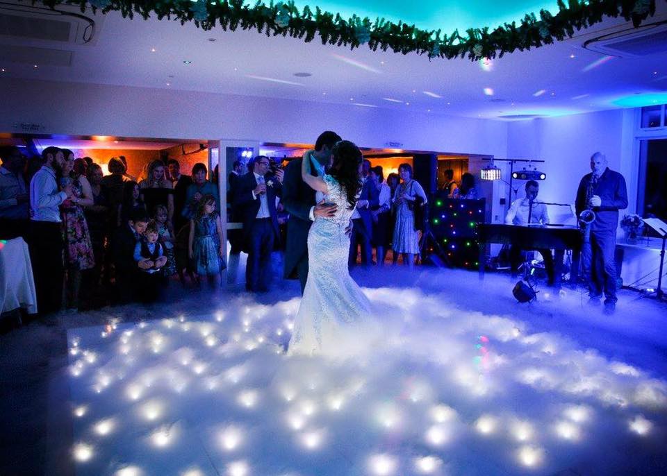 Twinkle dance floor covered with smoke and a couple doing their first dance