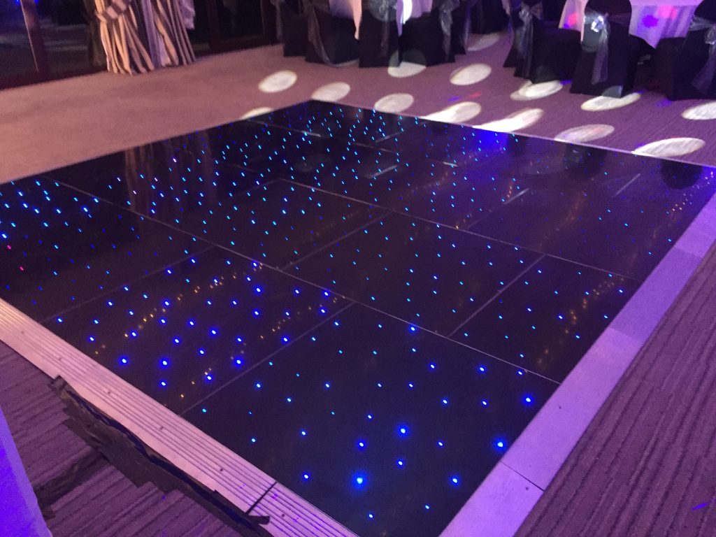 Black starlit dance floor with blue LEDs