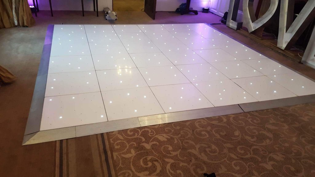 Starlit white dance floor in the middle of a room