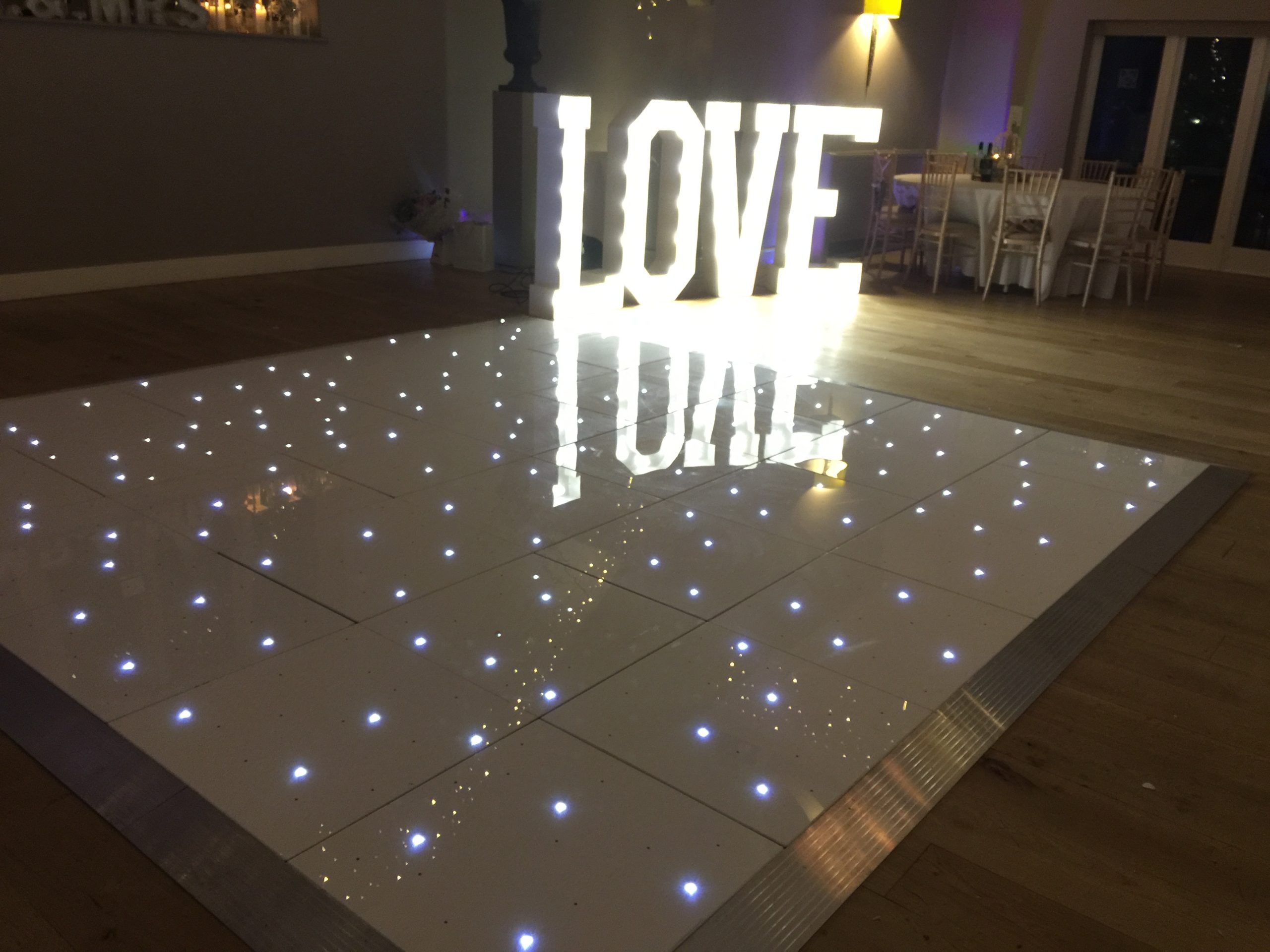 White starlit dance floor with giant light up LOVE behind