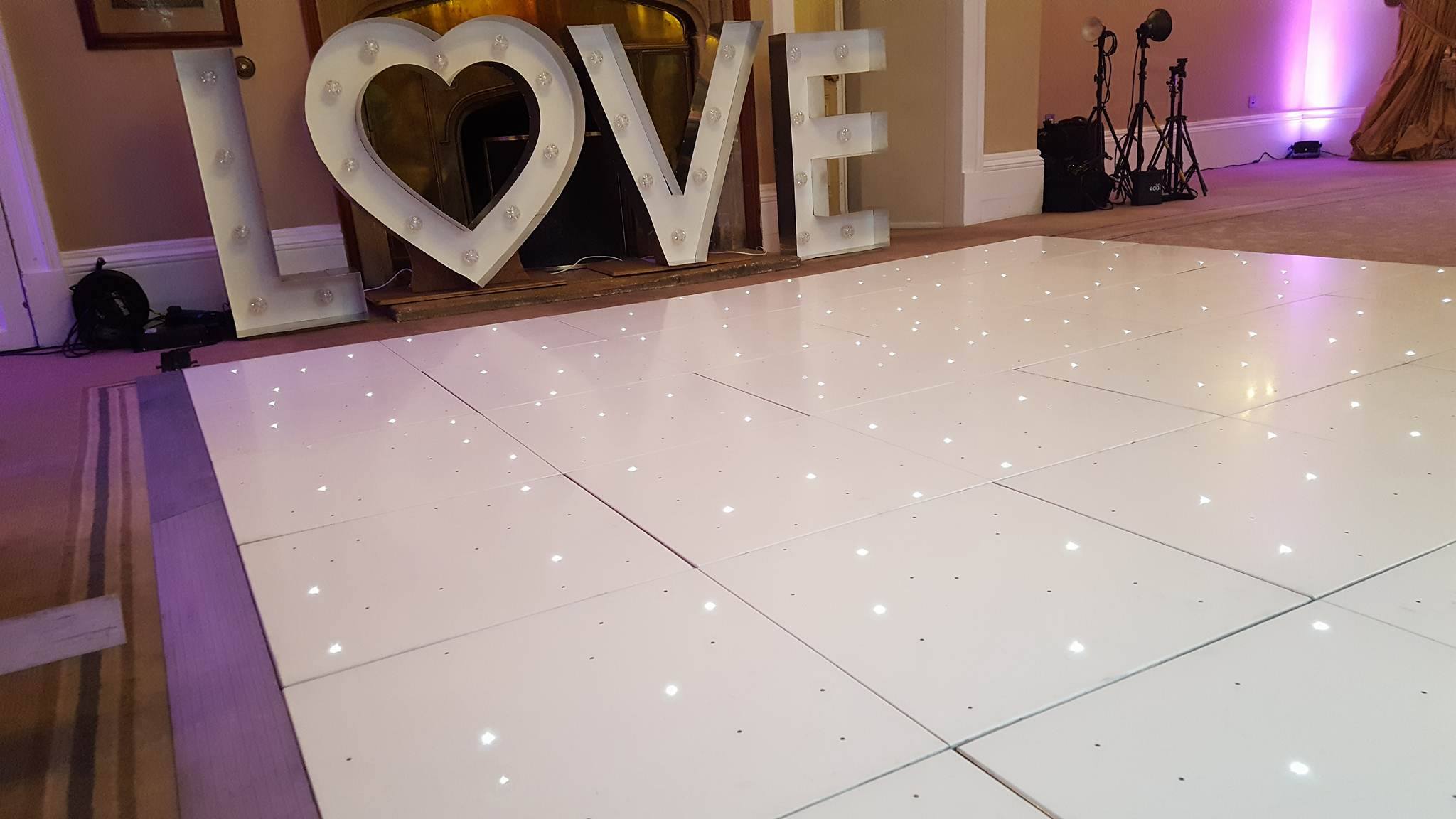 LED dance floor ready for a wedding with LOVE letters behind