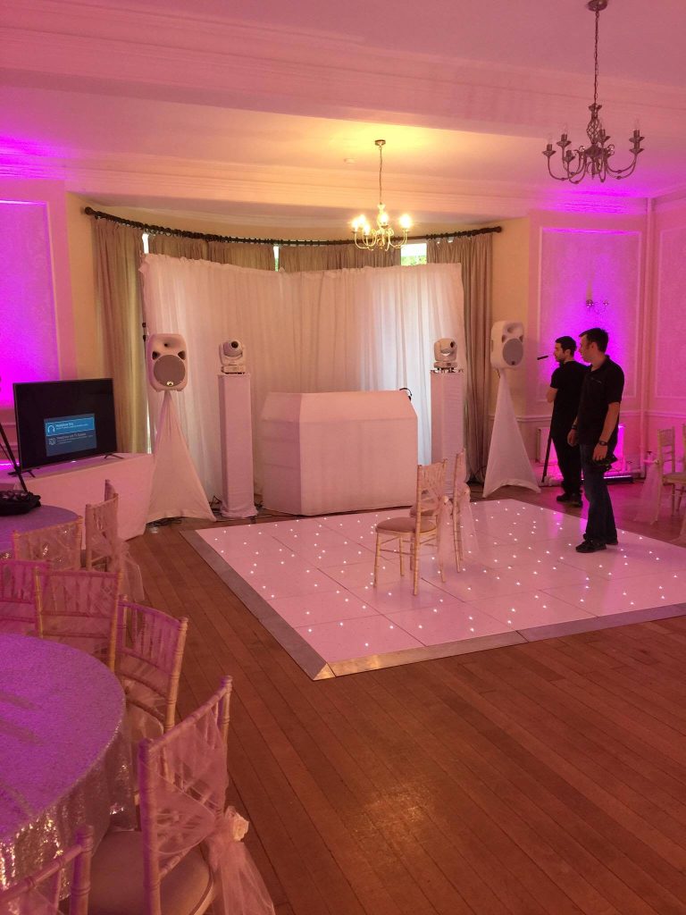 White LED dance floor with a white disco setup and white backdrop