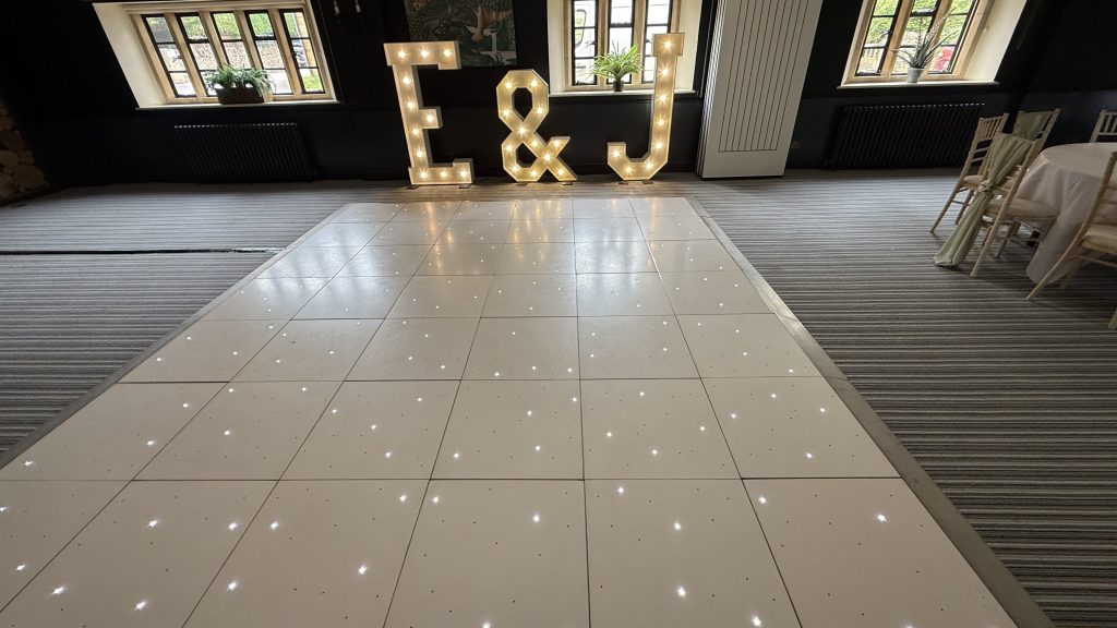 Light up E & J letters behind a white led dance floor