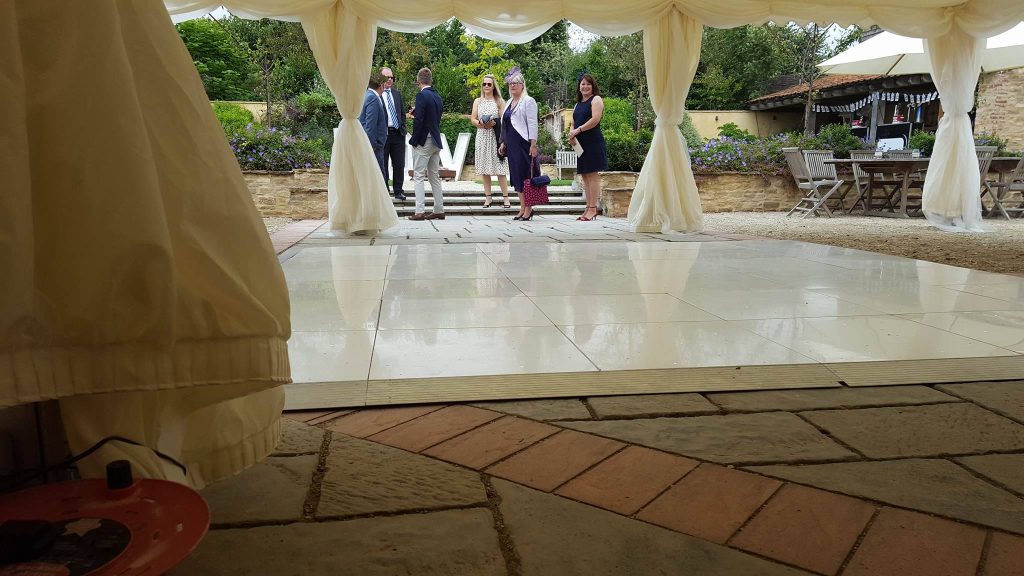 White dance floor with people in the background