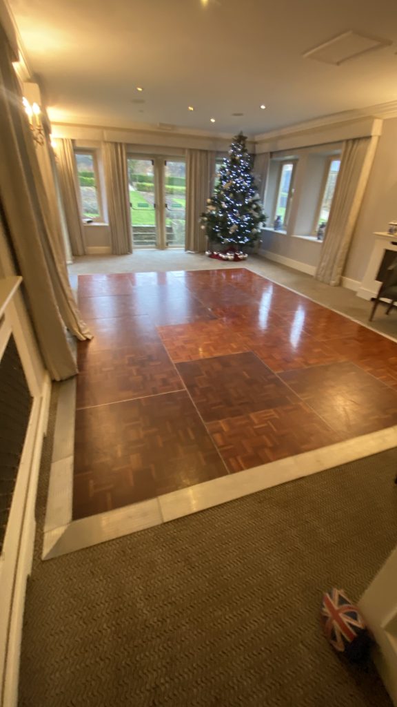 Wooden dance floor with christmas tree behind
