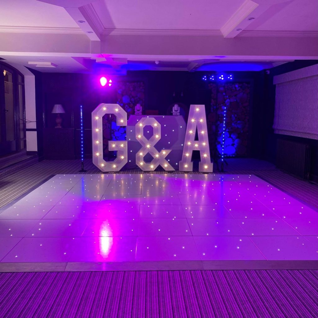 White starlit dance floor with giant light up letters