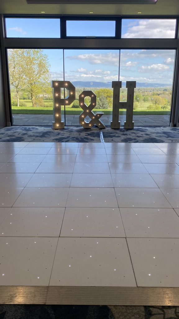 White led dance floor in front of light up letters