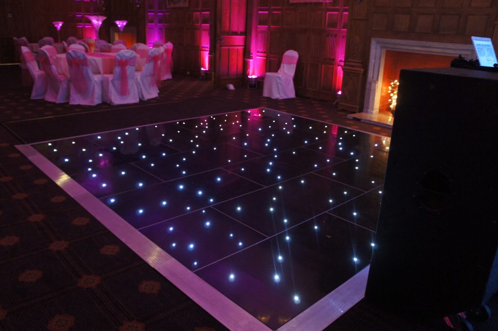 black led dance floor with pink lighting in the background. 