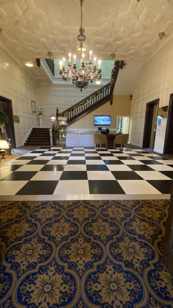 Black and white non led chequered dance floor in the reception hall at Dumbleton hall