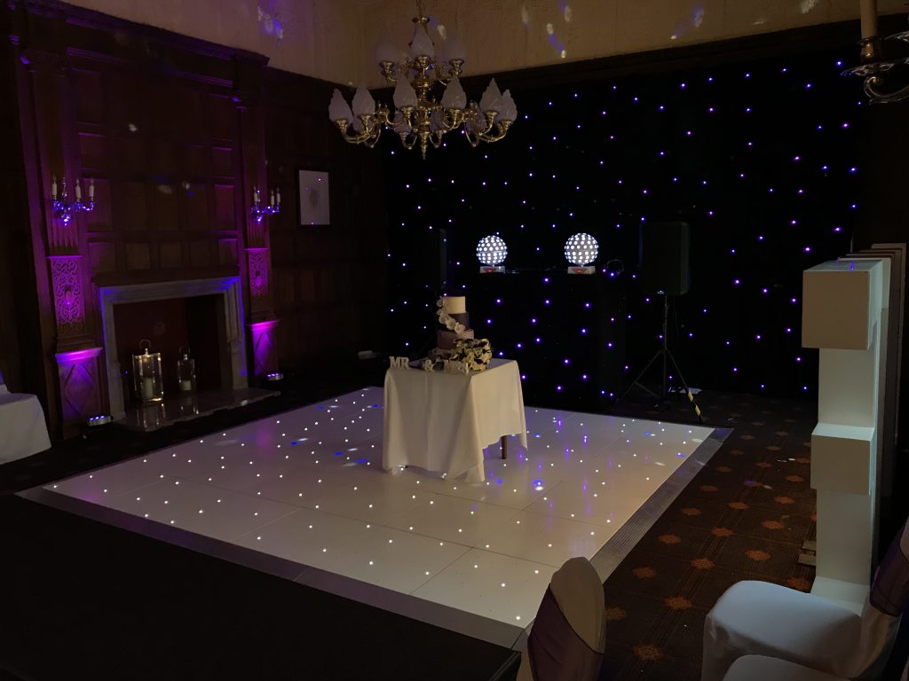 White LED dance floor with the cake table and cake on. 
