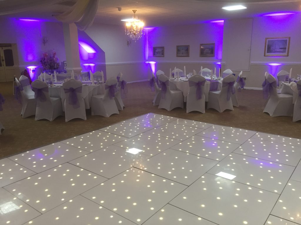White twinkle dance floor in with purple lighting. 