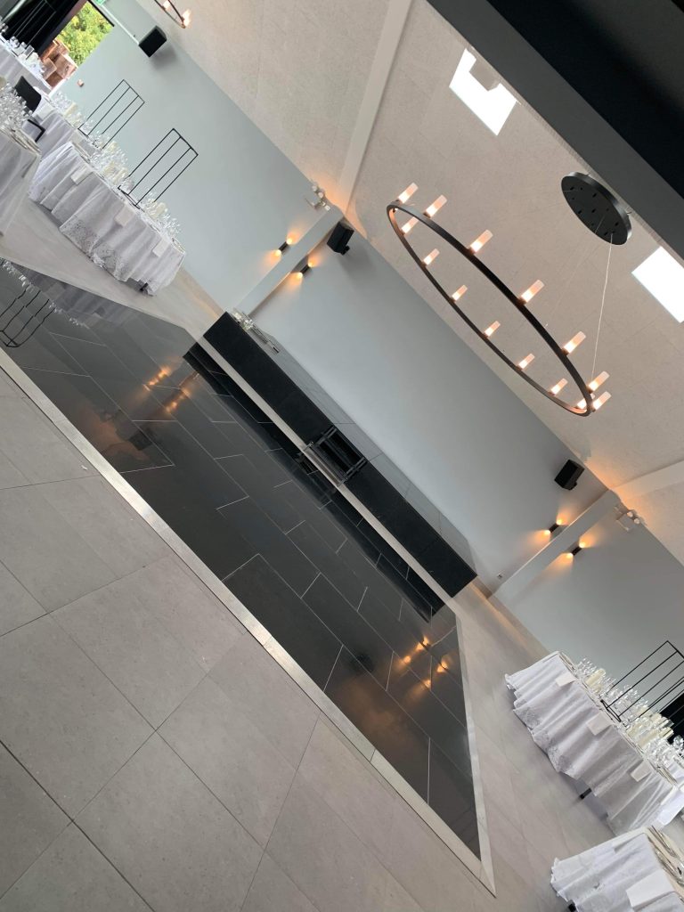 Pure black non led dance floor at Crumplebury Barns in front of a small stage