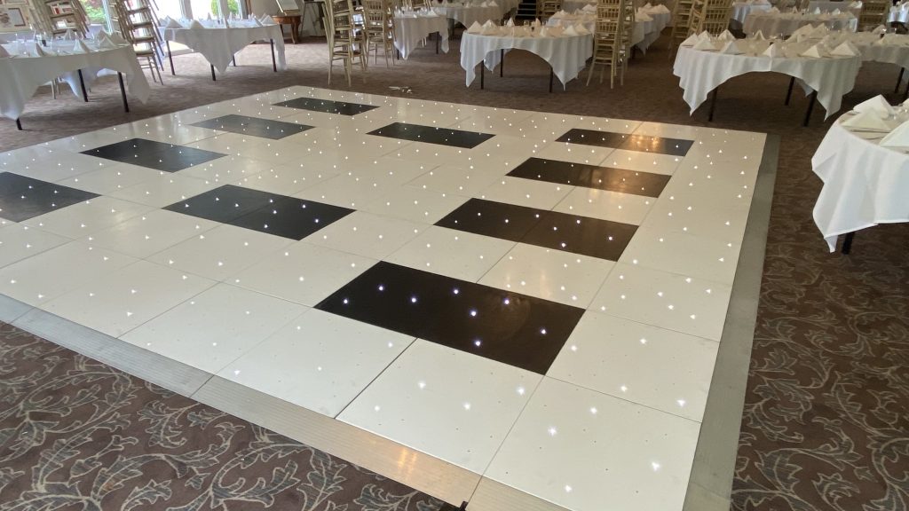 White starlit dance floor with black centre square sections. 