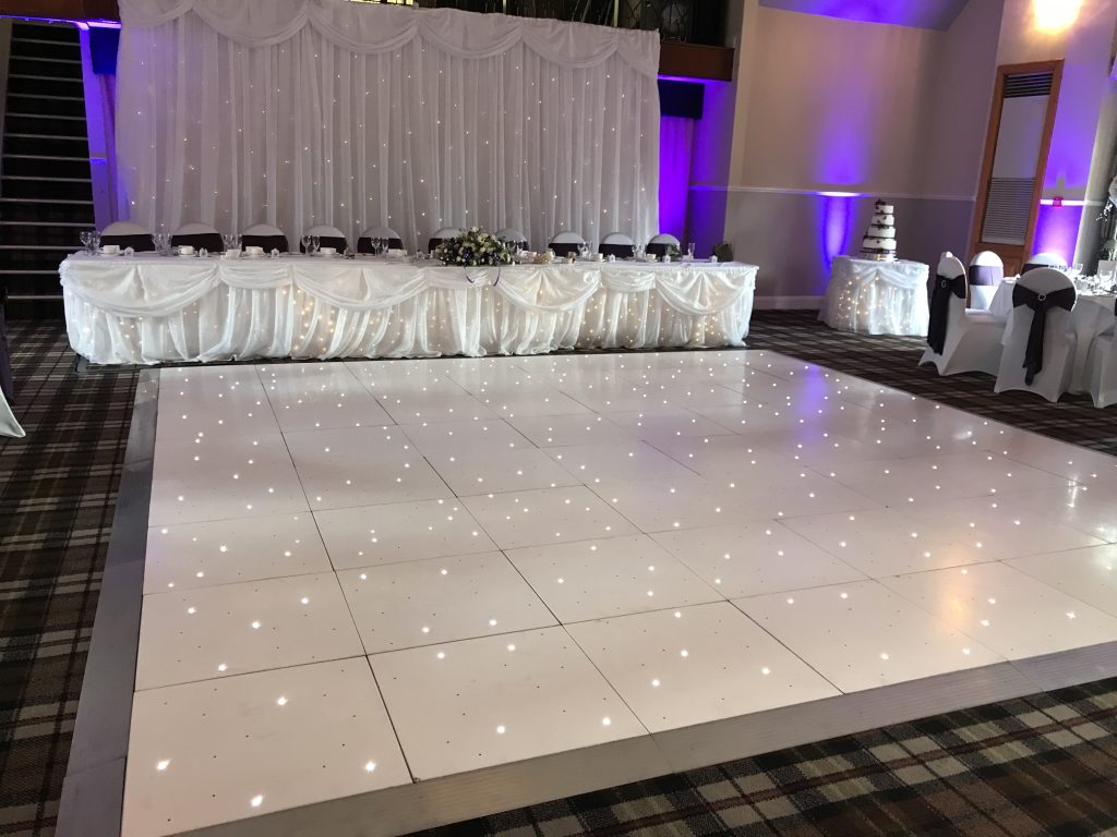 White starlit dance floor setup in front of the top table