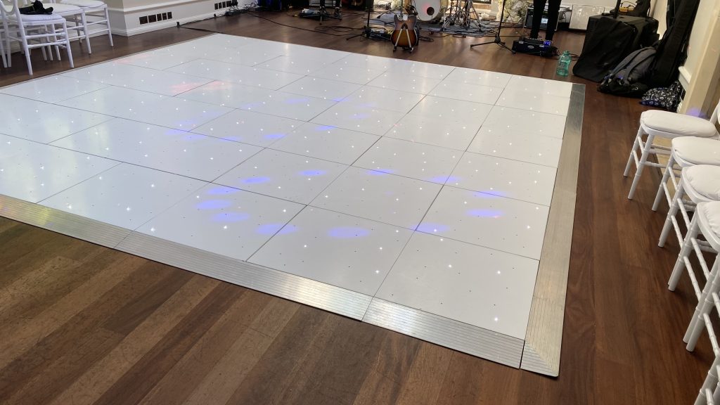White LED starlit dance floor with chairs around the outside