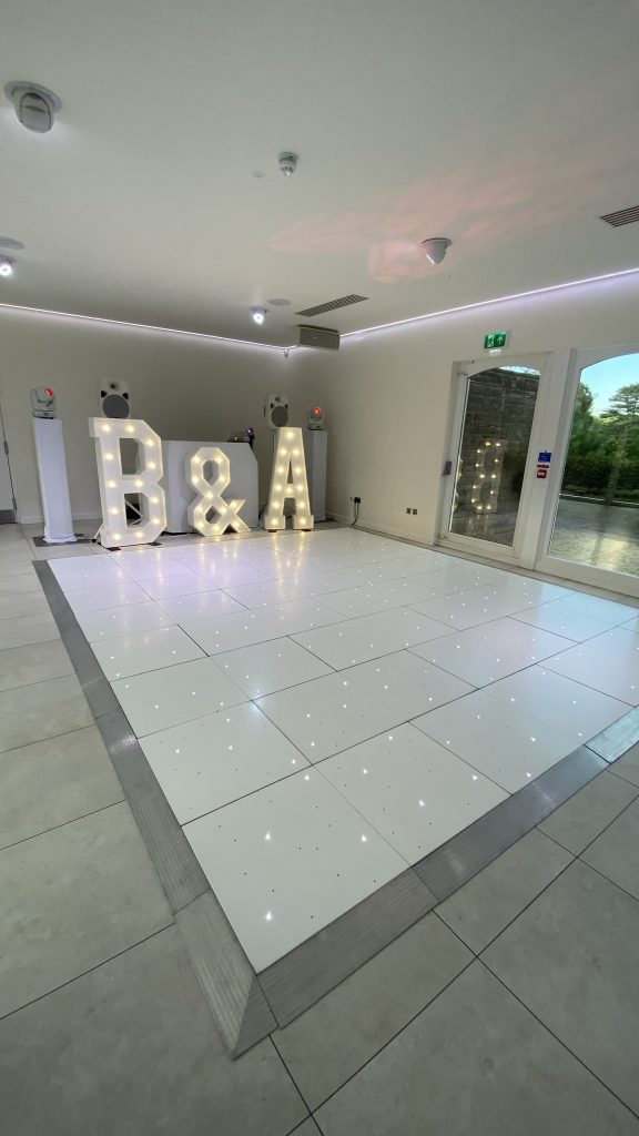 White led starlit dance floor with B & A light up letters and white DJ and disco setup behind. 