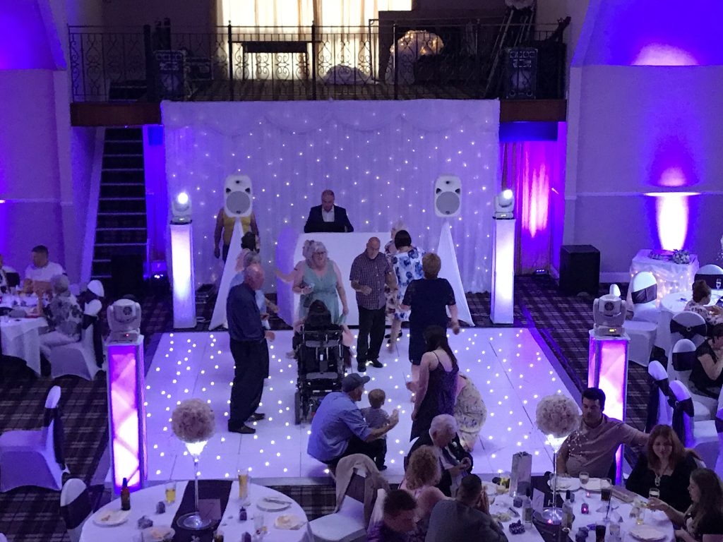 People dancing on a white starlit dance floor