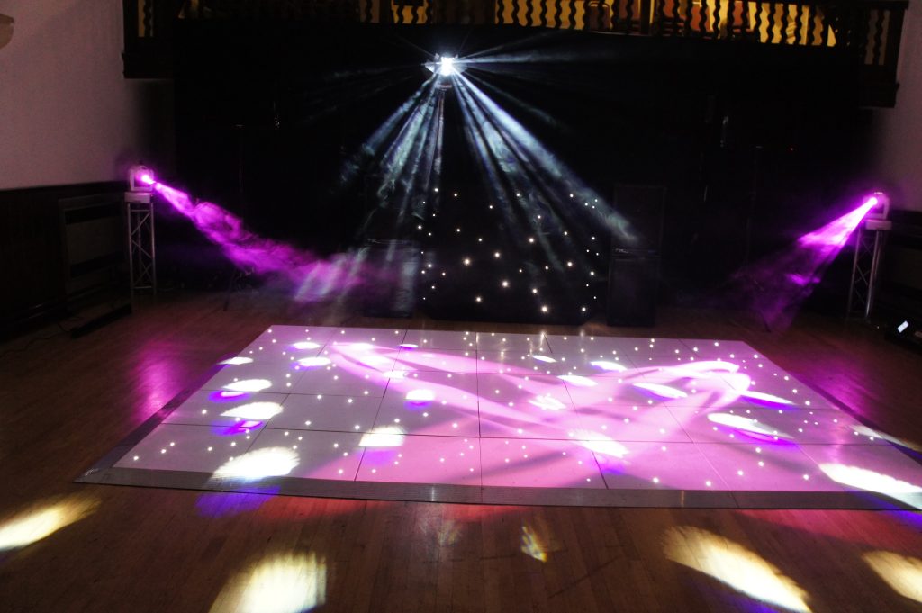 White Starlit dance floor with effects lighting shining onto it. 