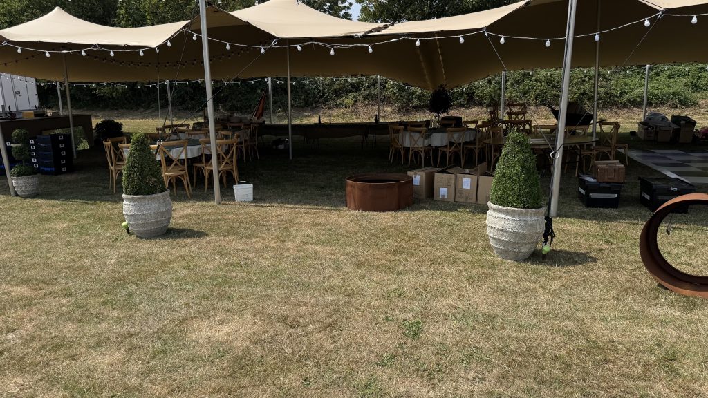 Inside of a stretch tent at a farm wedding with dance floor
