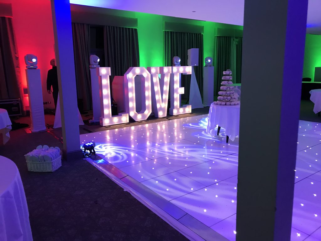 White Starlit dance floor in the courtyard at Walton hall