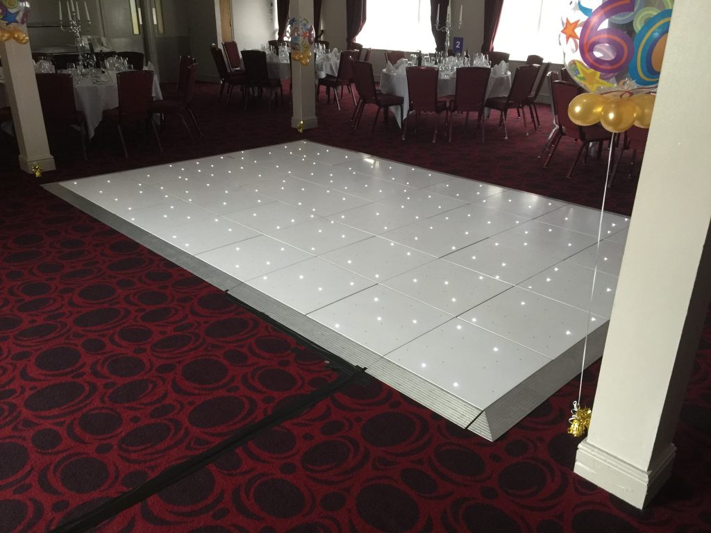 White Starlit dance floor in the courtyard at Walton hall
