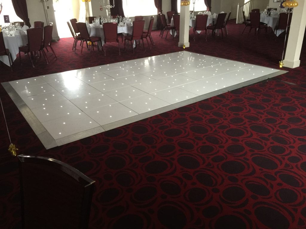 White Starlit dance floor in the courtyard at Walton hall