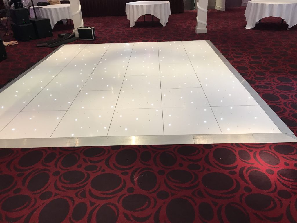 White Starlit dance floor in the courtyard at Walton hall