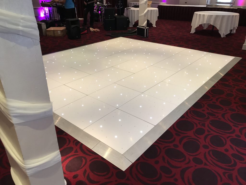 White Starlit dance floor in the courtyard at Walton hall
