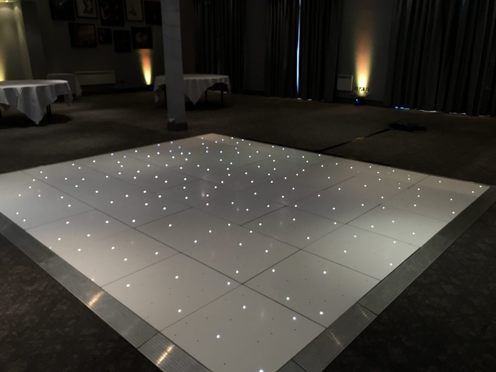White Starlit dance floor in the courtyard at Walton hall