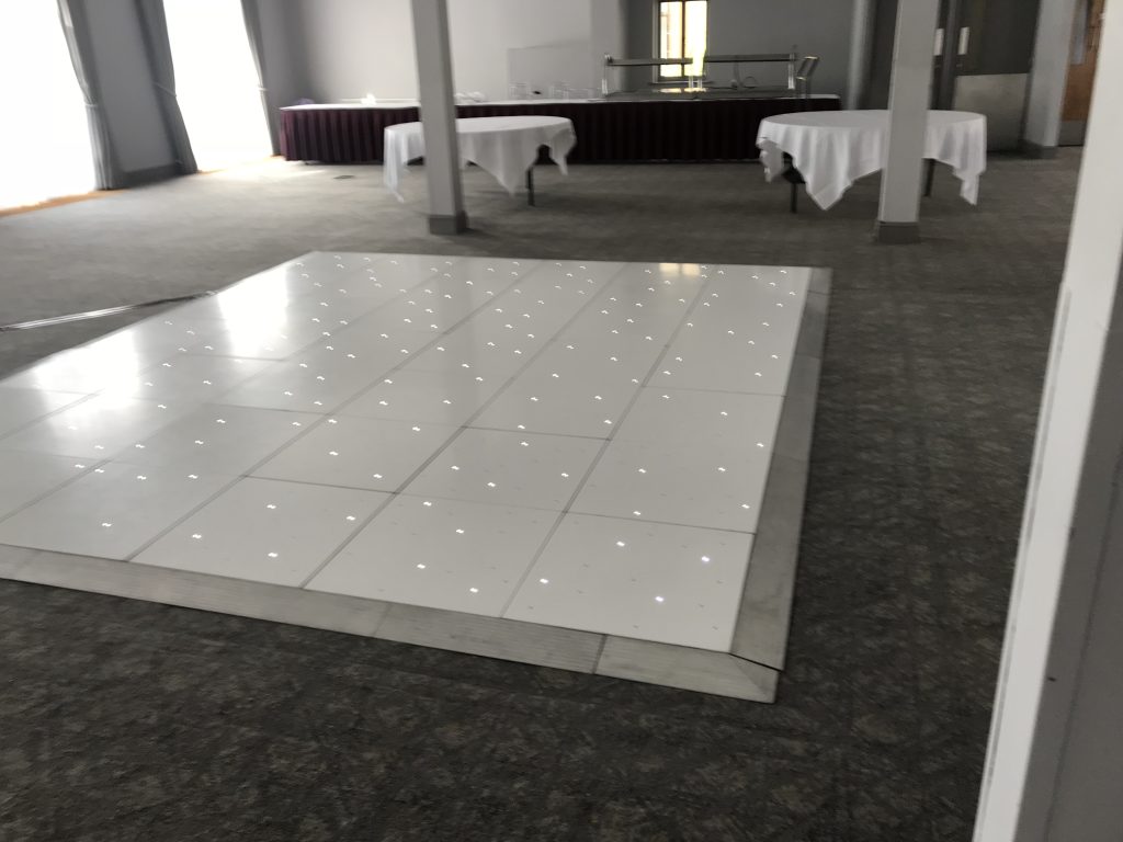 White Starlit dance floor in the courtyard at Walton hall