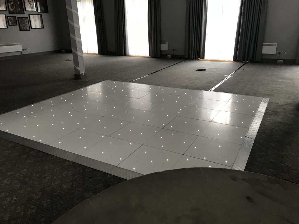 White Starlit dance floor in the courtyard at Walton hall