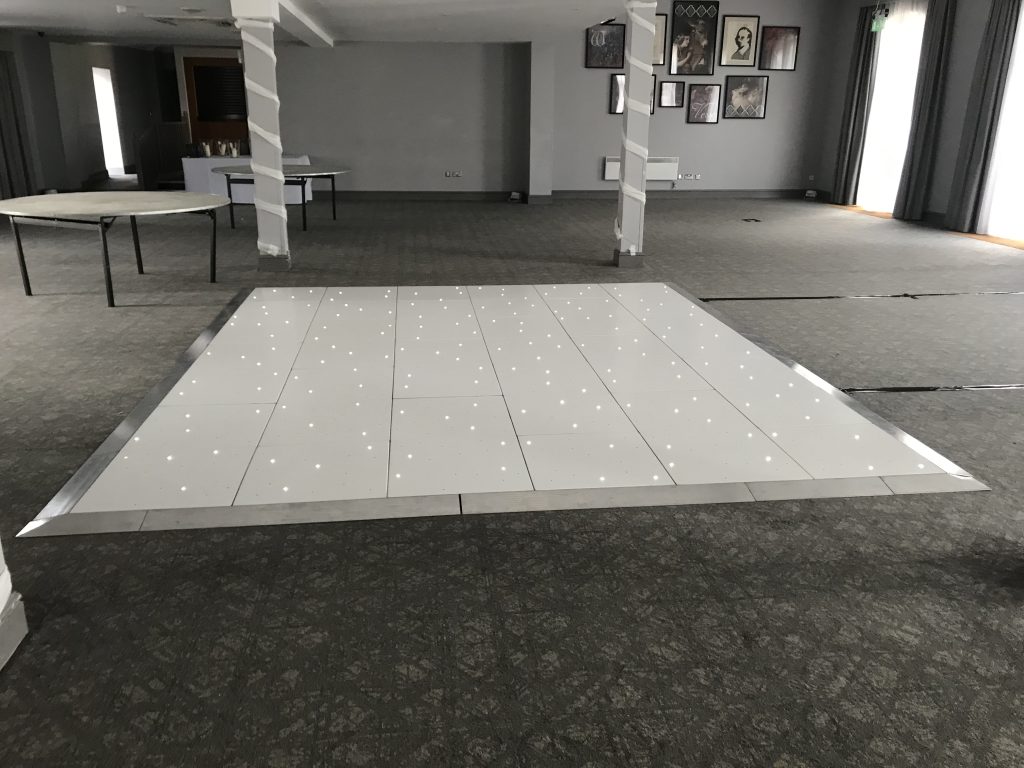 White Starlit dance floor in the courtyard at Walton hall