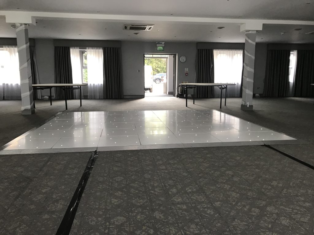 White Starlit dance floor in the courtyard at Walton hall
