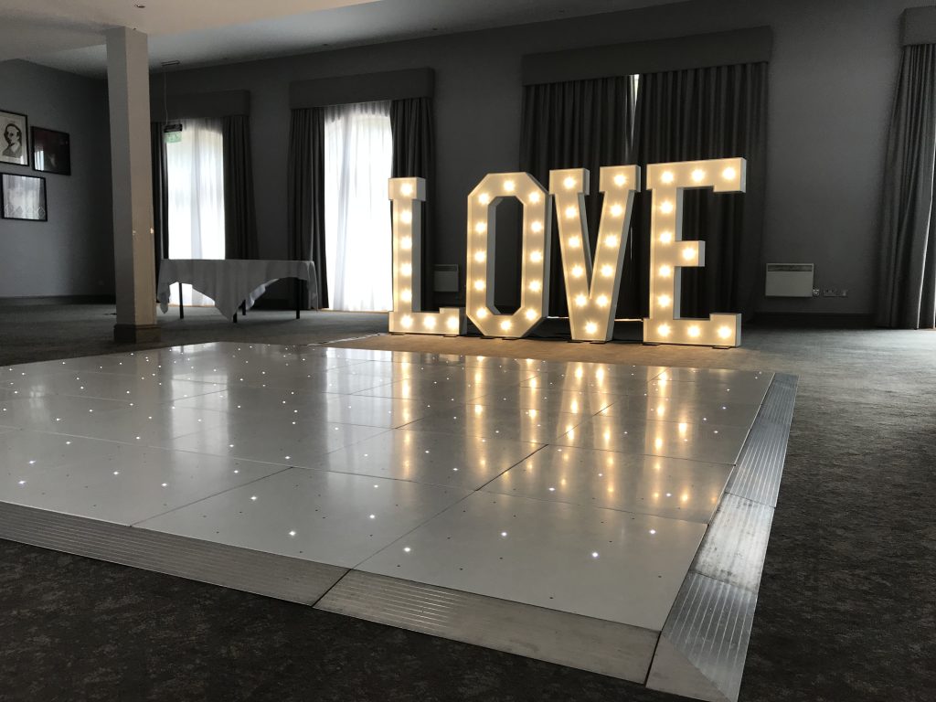 White Starlit dance floor in the courtyard at Walton hall