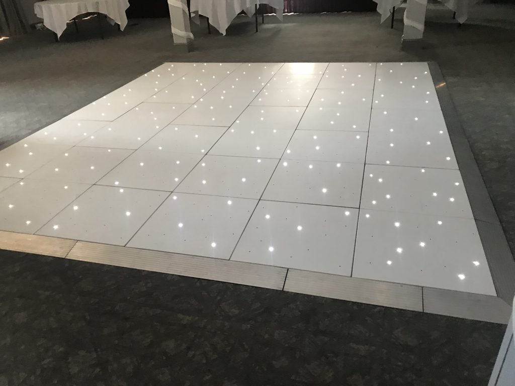White Starlit dance floor in the courtyard at Walton hall