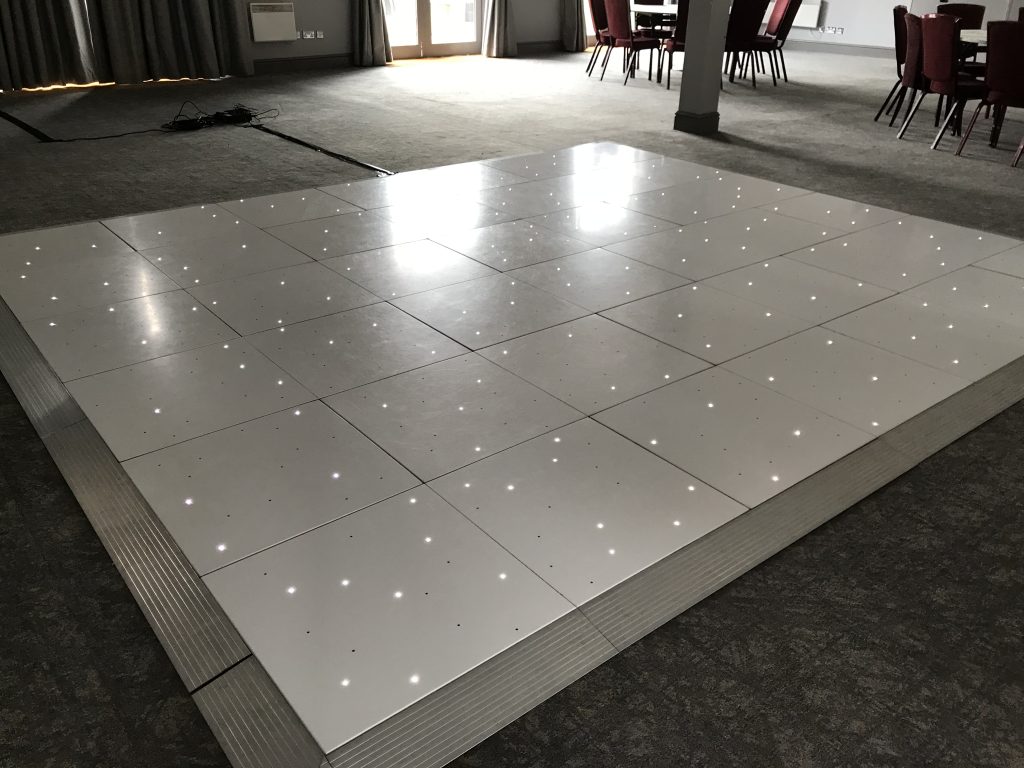 White Starlit dance floor in the courtyard at Walton hall