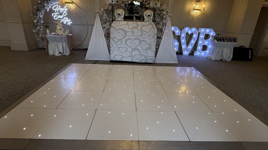 White dance floor led starlit with heart DJ booth behind and white speakers