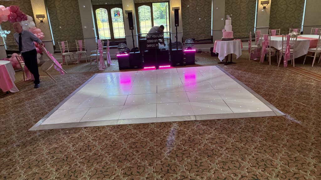 White LED dance floor setup in front of a DJ