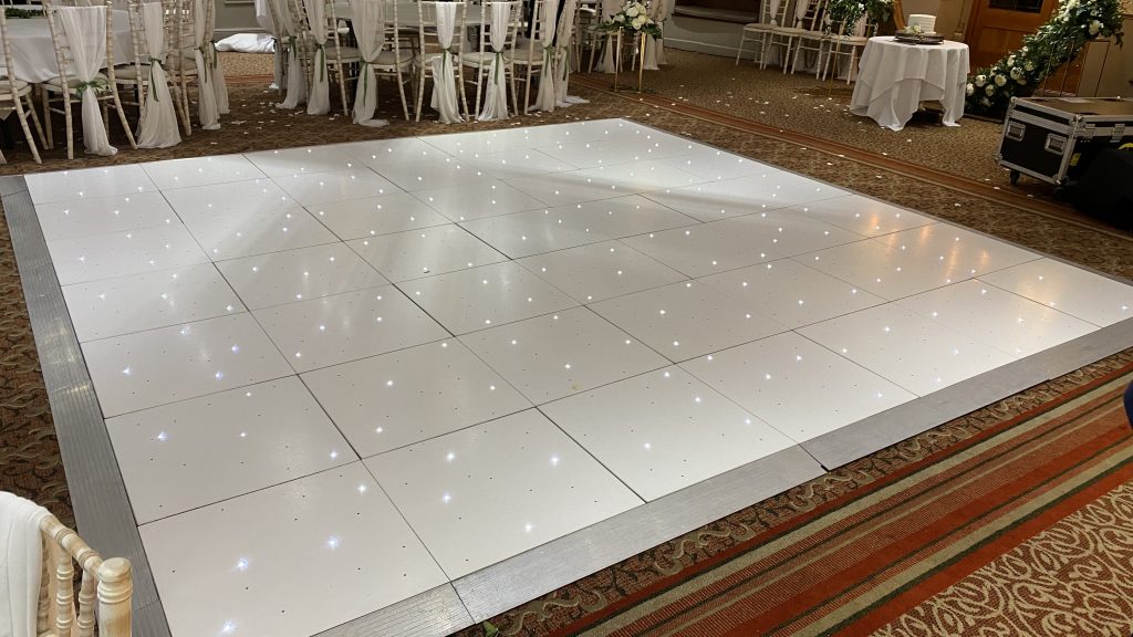 A 14' x 14' white starlit dance floor