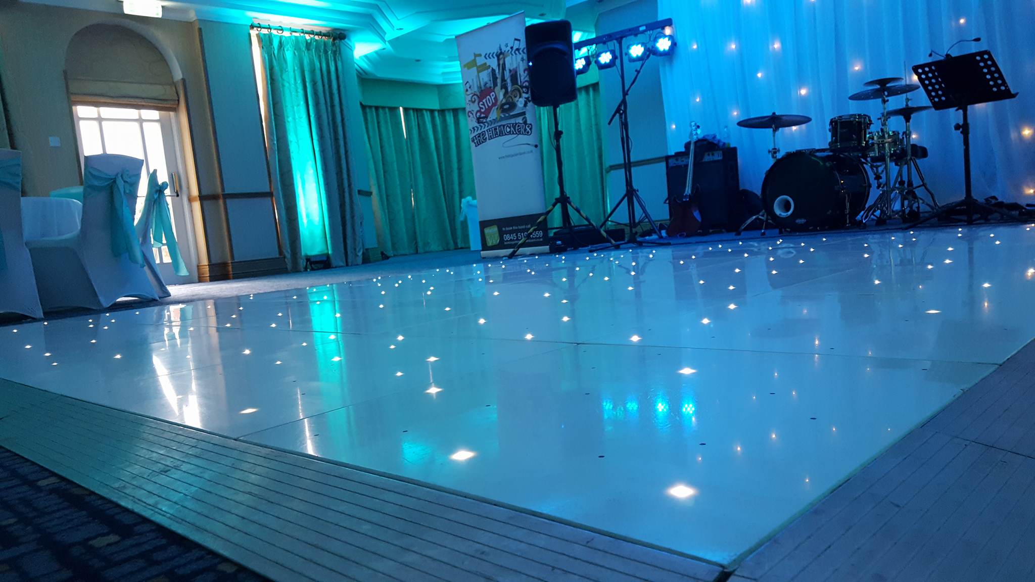 LED White starlit dance floor with blue lighting around the room